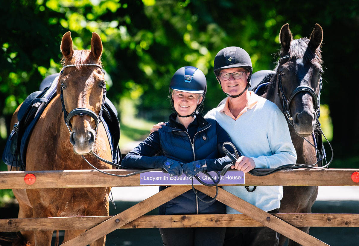 equestrians-smiling-across-a-gate-with-their-horse