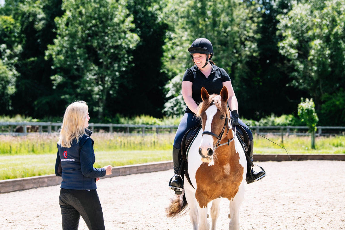 horse-rider-smiling-at-their-instructor-whilst-practicing